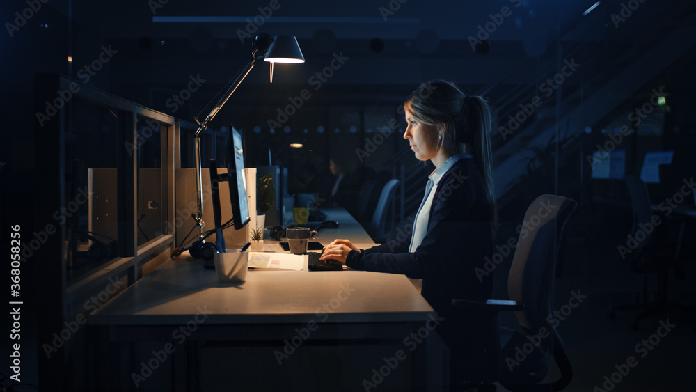 Poster Working Late at Night in the Office: Businesswoman Using Desktop Computer, Analyzing, Using Documents, Solving Problems, Finishing Project. 
