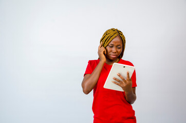 a young beautiful african lady wearing red clothe isolated over white background feeling weak,...