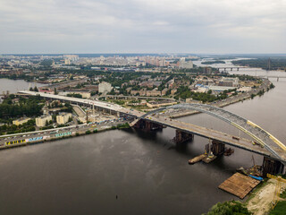Obraz premium Construction of a bridge across the Dnieper river in Kiev. Aerial drone view.