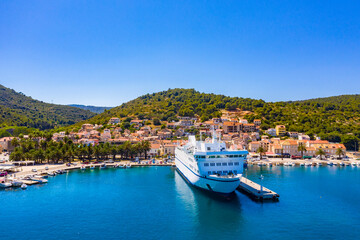 Fototapeta na wymiar VIS, VIS ISLAND, CROATIA Aerial view of the city and port with passenger ferry which connects Split and Vis