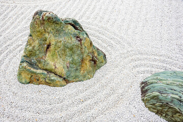 Japanese zen garden meditation stone in lines sand for relaxation balance and harmony spirituality...