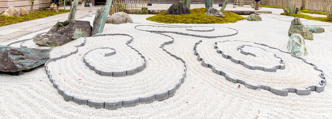 Japanese zen garden meditation stone in lines sand for relaxation balance and harmony spirituality or wellness in Kyoto,Japan