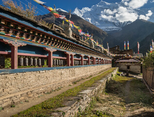 Prayer Wheels wall in Upper Pisang village, Around Annapurna trek, Manang district, Gandaki zone, Nepal Himalaya, Nepal.