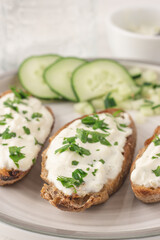 Mediterranean bruschetta with tzatziki, cucumber and parsley.