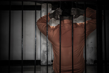 Asian man desperate at the iron prison,prisoner concept,thailand people,Hope to be free,Serious...