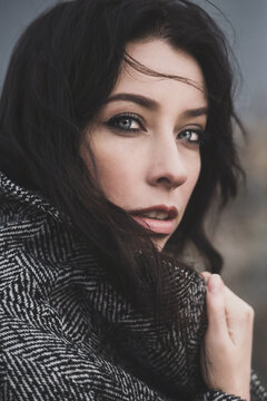 Attractive brunette woman portrait in coat outdoor