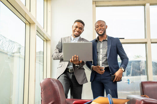 Two Young Black Business Men Standing Together Smiling