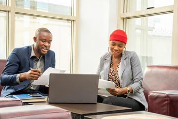 young african business man and woman going through some paperwork together