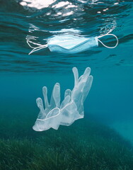 Gloves underwater and face mask floating on water surface, plastic waste pollution in the sea, coronavirus COVID-19 pandemic, Mediterranean sea