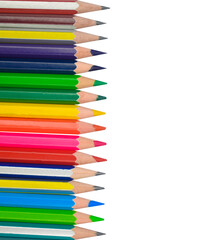 One line of different colored wood pencil crayons placed on a white background