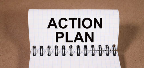 Top view of clipboard and white sheet written with ACTION PLAN. Business Concept.