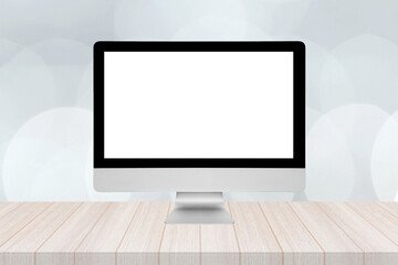 Smart modern pc with blank white screen on wooden table and modern bokeh wall in background.Elegant...