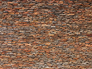 High horizontal brick wall faced with fine slate stone. Copy space text design background