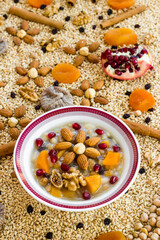  Traditional Turkish Dessert Ashure or Noah's Pudding in white bowl on ingredients of Ashure Dessert,vertical image