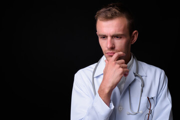 Portrait of young handsome man doctor with blond hair