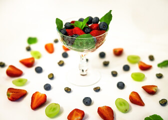 berry cocktail in a crystal glass with strawberries, blueberries, blueberries and mint close up	
