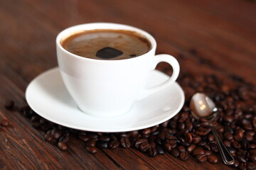 Cup of Coffee and Coffee Beans on wooden plank table