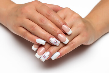 Wedding french white manicure with white painted flower on a white background close-up on long square nails. Gel design.