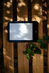 Ebook Reader on a wooden table with a green plant