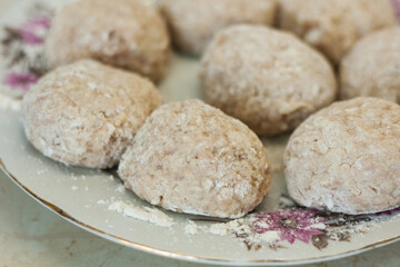 homemade meatballs on the plate in the kitchen - making minced meatballs, traditional Italian cuisine