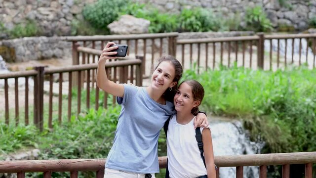 Two sisters doing a selfie in a beautiful place on their vacation