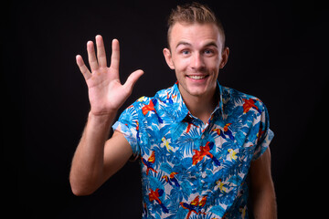 Portrait of young handsome tourist man ready for vacation