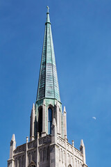 Fototapeta na wymiar Fairy tale spire of Tulsa with copper roof and half moon in sky