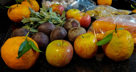 A small variety of fruits and vegetables that have just arrived from the organic fair.