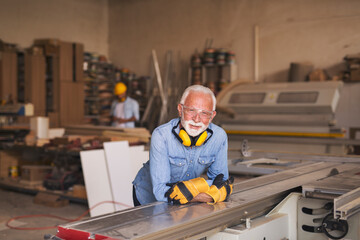 Mature elderly joiner at work