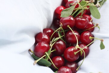 Ripe cherries in the hem of a blue dress 