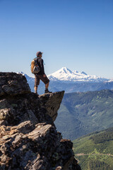Fototapeta premium Adventurous Person Hiking in the Canadian Mountains during a sunny summer morning. Taken on the Trail to Cheam Peak in Chilliwack, East of Vancouver, British Columbia, Canada.