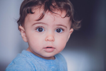 Naklejka premium portrait of a baby boy with long hair 