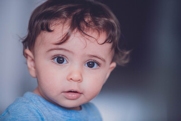 portrait of a baby boy with long hair 