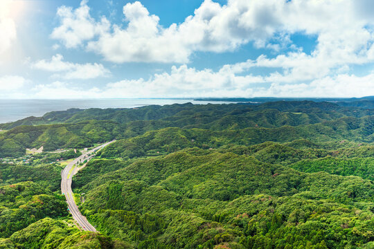 High angle view of Uraga Channel and Kanaya fishing village with the Futtsu-Tateyama Road in the mountains of Boso peninsula from the cliff of the Mount Nokogiri quarry.