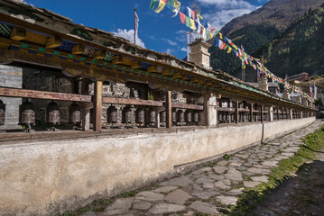 View of the prayer wheels wall in Lower Pisang village, Around Annapurna trek, Manang District, Gandaki zone, Nepal Himalayas, Nepal.