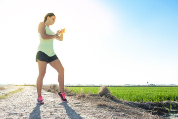 Young athlete girl checks her watch