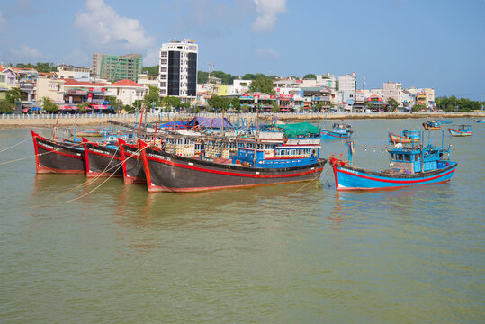 NHA TRANG, VIETNAM - DECEMBER 30, 2015: Fishing schooners in the background of the city's waterfront on the river Kai