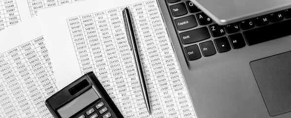 Top view of working space with financial reports, laptop, calculator and pen. Top view. Business planning concept on white.