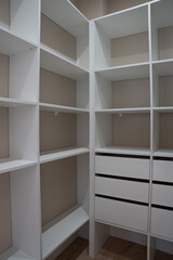 Fototapeta premium Light empty wardrobe, with white shelves