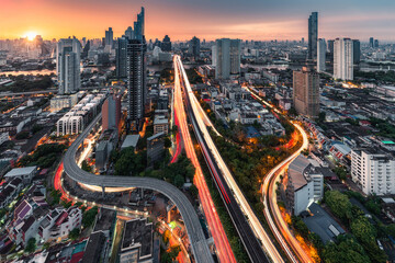 Fototapeta na wymiar Sunrise over Trident road at Sathorn, Taksin bridge and illuminated traffic at Bangkok