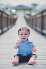 baby on a bridge laughing 
