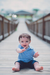 baby on a bridge laughing 