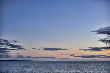 picturesque view of endless seascape with fluffy clouds in sky at sunset