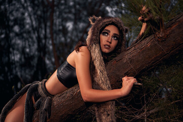 Fototapeta na wymiar the wolf girl. wild predator. background is green forest