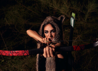 Girl portrait in the image of wolf. background is forest