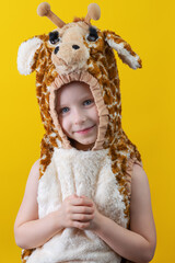 Close-up portrait of a cute little girl. Studio shot over yellow background. Childhood concept.
