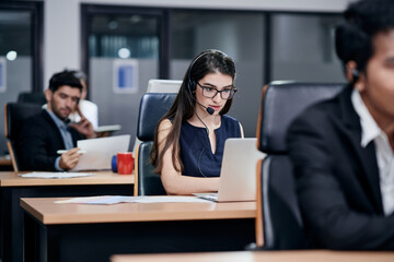 Young European woman who is working as a call center agent is on call with a customer.