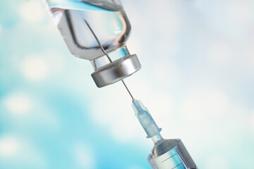 Vaccine medicine bottle and syringe injection use for prevention and treatment of virus infection disease.Medical personnel are preparing vaccines for medical treatment. © MemoryMan