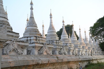 Fototapeta na wymiar White stupas in Kuthodaw pagoda temple at Mandalay city. Myanmar (Burma). 