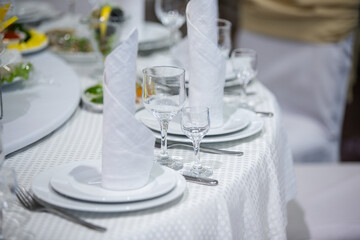 Banquet table with food and dining utensils.